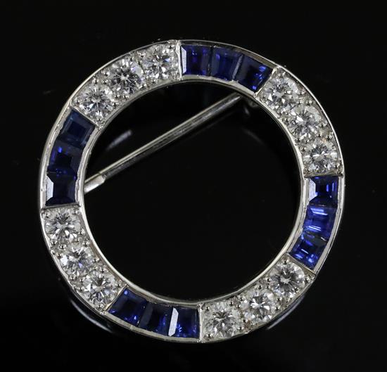 A modern Boodle & Dunthorne 18ct white gold, sapphire and diamond openwork circular brooch, 24mm.